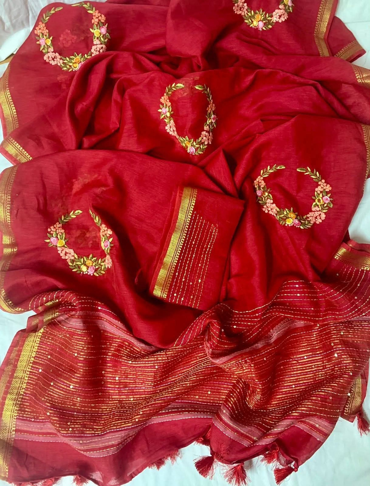 Red handwoven Kota silk linen saree with floral embroidery and golden zari border from Bhagalpur
